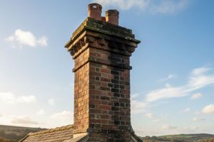 two men climb down a chimney